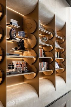 the bookshelves are lined up against the wall with circular shelves on each side