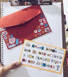 a person holding a piece of paper next to an envelope with magnets on it