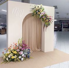 flowers are placed on the floor in front of a stage set up for an event