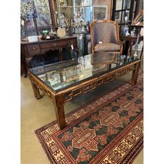 a glass top coffee table with chairs and rugs