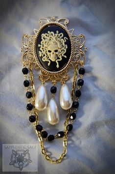 Take the plunge and make a bold fashion statement with the "Medusa" Brooch. With its captivating medusa cameo and sparkly hand-wired glass bead strands, it's the perfect accessory to give your Pirate festival look an edge. Dare to be different! 40x30mm stone, overall size is 2 inches by 4 inches Gothic Formal Jewelry Brooch, Gothic Brooch Jewelry For Parties, Gothic Party Brooch Jewelry, Gold Cameo Jewelry For Party, Medieval Times Dinner, Pirate Festival, Portrait Jewelry, Wired Glass, Akron Ohio