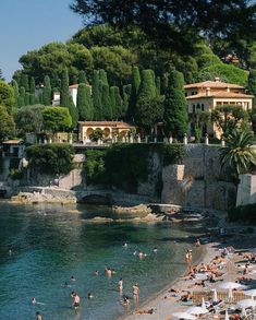 many people are on the beach and in the water