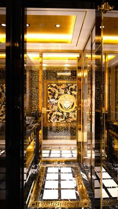 the inside of a building with gold and black decor