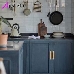 a kitchen with pots and pans hanging on the wall next to a counter top