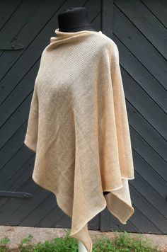 READY TO SHIP Elegant, comfortable, wide knitted natural  linen poncho, shawl wrap. Linen is breathable and most suitable material for the skin. Great accessory for occasions or everyday wearing. Material :  Linen, silk,polyamide. Colour: Beige, Champagne Beige. ONE SIZE. Fits to sizes S,M,L,XL,XXL CARE INSTRUCTION: Gentle cool hand wash +30 C , lay flat on surface to dry.  For more knitted accessories and clothing, visit my shop: https://www.etsy.com/shop/LovesomeKnittings Thank you for shoppin Cozy One Size Poncho For Beach, One Size Shawl Cape For Beach, Beige One Size Shawl Poncho, Cozy One Size Shawl Cape, Cozy One-size Shawl Cape, Cozy Shawl In Cape Style One Size, Beige Shawl Poncho For Beach, Cozy Shawl Poncho With Scarf, Beige Wrap Shawl One Size