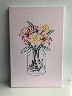 a pink canvas with flowers in a mason jar