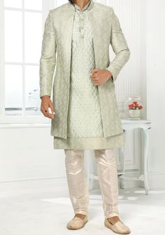 Readymade Art Silk Sherwani, and Jacket. Art Dupion Aligarhi Ready Made Trouser. Resham, Sequences, and Zari Work. Crafted in Chinese Collar Neck, and Full Sleeve. Faux Satin Lining with Plain Work. High-Quality Matching Buttons. Please Note: The footwear shown in the picture is for presentation and photography purpose only. Color: There might be slight color variation due to lightings and flashes while photo shooting. The color may also vary because of different screen resolutions. Wash Care: D Straight Kurta Outerwear For Eid, Straight Kurta For Eid Festivities, Bollywood Style Outerwear With Zari Work For Festive Season, Festive Outerwear With Dupatta For Eid, Formal Pista Green Set With Zari Work, Elegant Designer Outerwear For Diwali, Festive Eid Outerwear With Dupatta, Elegant Outerwear With Dupatta For Eid, Fitted Long Outerwear For Festive Season