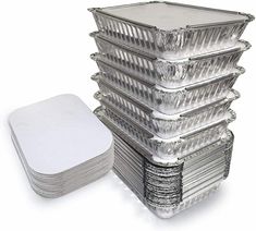 large stack of aluminum foil containers with one white square lid and six smaller ones stacked on each other