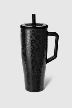 the black leopard print travel mug is shown