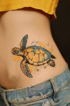 a woman's stomach with a turtle tattoo on it