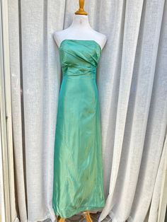 "1970's Jim Helm Occasions strapless formal dress. Made in USA. This stunning vintage dress in nice teal color features strapless style with gathered side detail. The bodice is boned for structure. Back zipper closure.  Fully lined. 100% acetate Good preowned condition. There's a small stain on the bust and few stains towards the hem (see photos ) Marked size 2. The mannequin is size 4, so I couldn't fully zip the dress. The zipper is fully functioning. Measurements (flat): Armpit to armpit: 14\" Waist: 26\" Hips: 36\" Top to hem: 51\"" Green Strapless Dress With Sweetheart Neckline And Fitted Bodice, Green Strapless Dress With Sweetheart Neckline, Green Strapless Evening Dress With Fitted Bodice, Green Strapless Dress For Prom, Green Strapless Dress With Fitted Bodice, Green Strapless Dress For Gala During Prom Season, Green Strapless Dress For Gala Prom Season, Green Strapless Dress For Gala Prom, Strapless Green Evening Dress With Ruched Bodice