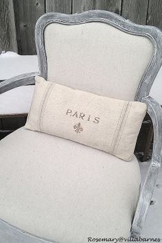 a chair with a pillow that says paris on it