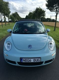 the front end of a blue volkswagen beetle