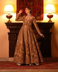 Lehenga Jacket Golden Bridal Dress Pakistani is a traditional choice to wear on the big day. This royal masterpiece is hand-embellished with resham and zardosi details, making this attire an epitome of grace and tradition. Lavish intricate designs and threads make this Pakistani Bridal Dress your foremost priority. Jacket: Bridal Jacket in the golden shade is gracefully adorned with shimmering crystals and stones. The lavish details of resham, zari, threads, and zardosi enhance the overall charm Traditional Hand Embellished Anarkali Set, Traditional Anarkali Set With Hand Embellished Drape, Traditional Hand Embellished Anarkali Set With Drape, Traditional Floor-length Hand Embellished Salwar Kameez, Traditional Hand Embellished Floor-length Salwar Kameez, Traditional Hand Embellished Gown For Eid, Traditional Hand Embellished Gown For Festivals, Traditional Hand Embellished Gown For Festive Season, Traditional Hand-embellished Gown For Festive Season