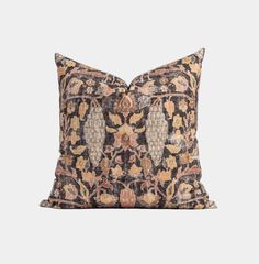 a black and gold pillow with an ornate design