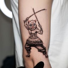 a person with a tattoo on their arm holding a knife and an evil looking cat