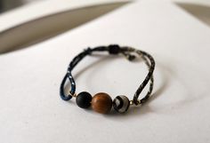 🤍 Sumpthin' Studio 🤍 This handcrafted bracelet combines the beauty of natural beads with a multicolored, durable cord, resulting in a unique and eye-catching piece.  The rich brown tones of the wood beads complement the intricate patterns of the Agate stones, while the multicolor cord adds a vibrant, playful touch.  The adjustable design ensures a comfortable fit, making this bracelet perfect for everyday wear. 🤍* Free U.S. Domestic Shipping / Not responsible for return shipping costs 🤍* Feel free to reach out if you need a different length 🤍*CARE INSTRUCTION* In order to maintain the shine and longevity of the jewelry, it is not recommended to contact the jewelry with water 🤍*THANK YOU FOR STOPPING BY *🤍 Adjustable Cord Bracelet, Tibetan Bracelet, Handcrafted Bracelets, Cord Bracelet, Brown Tones, Cord Bracelets, Braided Bracelets, Agate Beads, Intricate Patterns