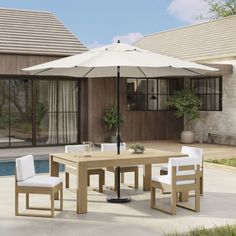 an outdoor table with chairs and umbrella next to a swimming pool in front of a house