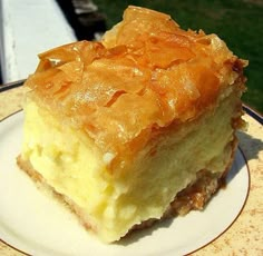 a piece of cake sitting on top of a plate next to a glass tablecloth