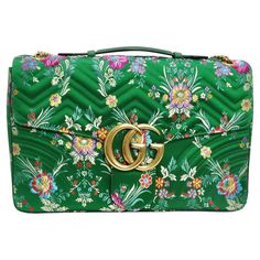 Introducing the Gucci Marmont Jacquard Matelassé Floral Maxi Top Handle Shoulder Bag—a true embodiment of luxury, craftsmanship, and exquisite design. This stunning shoulder bag is a visual masterpiece, showcasing Gucci's meticulous attention to detail and flair for creating statement accessories. Let's delve into the captivating features that make this bag a standout piece in the world of high fashion. The bag is crafted from a multicolored glossy floral-jacquard, adorned with intricate and det Gucci Dyonisus Bag, Gucci Purse Outfit, Gucci Green Bag, Gucci Purse, Gucci Purses, Floral Handbags, Green Handbag, Quilted Purses, Quilted Handbags