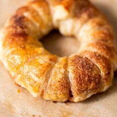 a close up of a doughnut on a piece of wax paper