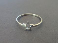 This listing is for a beautiful silver color Stainless Steel star ring. The simple ring features a classic silver color with a star outline design. This band comes in US/Canada sizes 6 through 10. Type- Ring Sub-Type- Stainless Steel Ring Style- Simple, Minimalist, Cute Size- US/Canada Sizing, 6-10 Accents- Star Outline Metal Type- Stainless Steel Color- Silver Why should you shop with Beadology By Heather? -We have a large amount of premium beads and supplies that we offer with your budget in m Rings Star, Ring Metal, Star Ring Silver, Star Rings Jewelry, Cute Star Accessories, Silver Star Rings, Stars Ring, Aesthetic Rings Silver, Cute Simple Rings