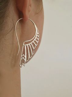 "* Solid Sterling Silver. * Pair of Feather Earrings. * 2.25\" long by 1.25\". Crafted with great detail, depth and dimension, in solid sterling silver, with standard size ear-stems. Inspired by the goddess Artemis, the goddess of the hunt. She is one of the most respected of all the ancient greek deities. Not only was Artemis the goddess of the hunt, she was also known as the goddess of wild animals, wilderness, childbirth, and protector of young children. The huntress earrings were created in Handmade Silver Wing-shaped Earrings, Elegant Sterling Silver Jewelry With Unique Design, Elegant Metal Wing-shaped Earrings, Elegant Wing-shaped Metal Earrings, Art Deco Sterling Silver Dangle Earrings, Handmade Sterling Silver Art Deco Earrings, Silver Sterling Silver Art Deco Earrings, Sterling Silver Art Deco Dangle Jewelry, Art Deco Sterling Silver Dangle Jewelry