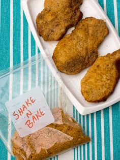 some food is sitting on a blue and white tablecloth with a sign that says shake oatmeal