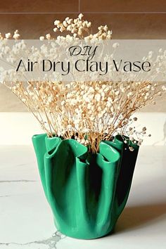 an air dry clay vase with dried flowers in it and the words diy air dry clay vase