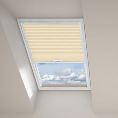 a bedroom with a skylight and white walls