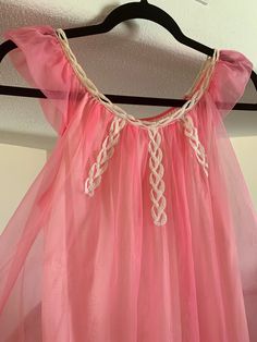 "Here we have an adorable bubblegum pink Designer nightgown from the 1960's. Two layers of fabric with the outer fabric a pretty hot pink chiffon. Very pretty white crisscross lacing at bodice. Sheer flutter sleeves. White interior lining. Size: Small Measurements while laying flat: Bust 18.5\" Waist 20\" Hips 24\" Length 34\" (Model shown is 6 feet tall and wears a size 6/8 dress and 34DD bust for sizing) This gown is in good vintage condition however there is a very tiny hole in the interior l Pink Sheer Dresses For Loungewear, Pink Bedtime Dresses For Summer, Cute Pink Dress For Pajama Party, Retro Bedtime Dresses For Summer, Pink Ruffle Dress For Loungewear, Cute Pink Party Sleepwear, Pink Ruffled Nightgown For Pajama Party, Pink Summer Bedtime Dress, Pink Lace Trim Dresses For Bedtime