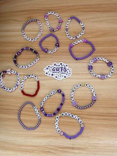 a bunch of bracelets sitting on top of a wooden table