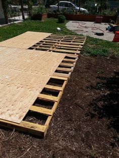 a large wooden ramp sitting in the middle of a yard