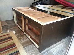 an unfinished kitchen cabinet in the process of being built with wood and plywood boards