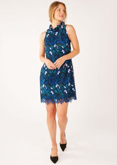 The Betty Dress is your go-to for effortless elegance. Crafted in a crochet-like daisy lace, this dress features a feminine ruffled neck, classic sheath shape, and playful scalloped hem. This timeless cocktail dress is easy and polished, making it the perfect choice for weddings, work parties, and family gatherings year-round. Ruffle neckline Sleeveless Back button closure Pull on over the head Scalloped hem Knee length Fully lined Fabric Content: Lace, 100% Polyester Care: Hand wash or dry clea Blue Scalloped Lace Summer Dress, Blue Scalloped Lace Dress For Summer, Blue Lace Mini Dress With Scalloped Lace, Blue Lace Mini Dress With Scalloped Detail, Blue Lace Trim Dress For Garden Party, Blue Scalloped Lace Mini Dress For Spring, Blue Mini Dress With Scalloped Lace For Spring, Spring Sleeveless Lace Dress With Scalloped Edges, Elegant Dress With Scalloped Edges For Garden Party