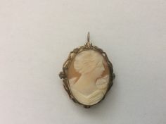 "12k gold filled cameo brooch pendant Very good condition size approximately - 1 1/4\" x 1 1/16\" marked: 1 - 20 D 12k wt. - 5.1 grams." Classic Cameo Brooches For Gifts, Antique Cameo Medallion Brooches, Gold Cameo Medallion Brooches, Formal Gold Cameo Brooch, Gold Cameo Medallion Brooch, Antique Cameo Medallion Brooch, Classic Oval Cameo Brooch, Antique Gold Cameo Brooches, Elegant Gold Cameo Brooch