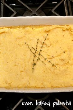 a casserole dish with some green sprigs on top