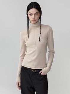 Soft texture viscose blend sheer turtleneck knit. Slim silhouette that naturally defines the body line - Clean point detail with a center line knit- Natural bottom hemming for a relaxed mood- Neckline adorned with a gold logo for added detail Beige Fitted High Neck Sweater, Fitted High Neck Beige Sweater, Chic Fitted Fine Knit Turtleneck, Beige Fitted Turtleneck Sweater, Fitted Beige Turtleneck Sweater, Fitted Beige Turtleneck For Spring, Fitted Beige Fine Knit Top, Fitted Fine Knit Beige Top, Fitted Fine Knit Turtleneck Top