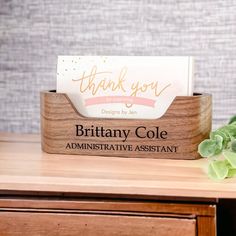 a wooden desk with a business card holder on it