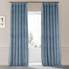 a blue curtain hanging in front of a window