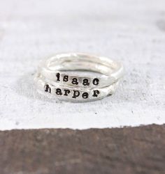 Silver Stacking Name Rings These beautiful keepsakes rings are absolutely gorgeous. They are made competely in our studio from start to finish from .999 pure silver. For MOST people, they will not tarnish like sterling silver, which is .925 silver. Each ring is THICK, so we dont Unique Hand Stamped Round Jewelry, Unique Hand Stamped Sterling Silver Rings, Customizable Silver Rings For Everyday, Artisan Ring With Stamped Detail As Gift, Artisan Stamped Rings For Anniversary, Handmade Adjustable Stackable Rings As Gift, Artisan Stamped Rings As Gifts, Artisan Hand Stamped Adjustable Jewelry, Artisan Adjustable Hand Stamped Jewelry