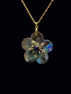 "A single flower is the focus of this one of a kind pendant; carved abalone petals with a starburst pistil dotted with tiny rhinestones!  It is both coastal and earthy; the rainbow colors of abalone are flashy and it is striking against a solid color. Here I started with an abalone flower charm measuring almost 2\" long including the gold tone bail, and 1.5\" wide.  I added a 24\" gold tone braided chain and a spring ring clasp, making the total length about 26\" long.  This allows you to slip t Siren Jewelry, Jewellery Lookbook, Depoe Bay, Abalone Jewelry, Flower Pendant Necklace, Jewelry Lookbook, Single Flower, Cute Necklace, Pretty Gift