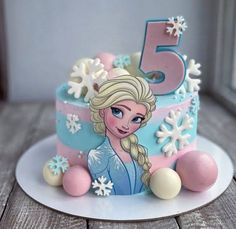 a frozen princess cake with the number five on it