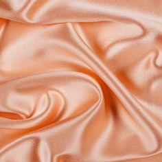 "The bridal satin is a luxurious 60\" wide, 100% polyester satin fabric. Known for its silky smooth touch and radiant colors, this high quality satin is ideal for: -glamorous gowns -bridal wear -bridesmaid dress -cocktail dresses -blouses and many other forms of apparel! FREE SHIPPING The bridal satin has a sturdy body and a soft drape which makes it great for curtains, drapes, table sashes and other event decor. It is your go to fabric for a medium-heavy drape that shines and shimmers with ever Robes Glamour, Stretch Satin Fabric, Silk Satin Fabric, Bridal Fabric, Shiny Fabric, Peach Fuzz, Coral Peach, Wedding Dresses Plus Size, Modest Wedding Dresses