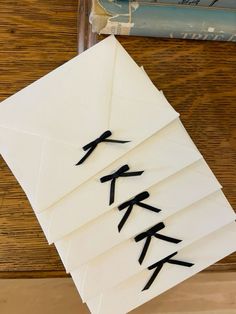 an envelope with japanese writing on it sitting next to a stack of books and magazines