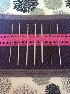 there is a pink strip on top of the knitting needles and it's crocheted