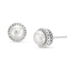 These earrings feature two freshwater pearls measuring 6.0-6.20 millimeters, each embraced by a halo of brilliant round cut diamonds totaling 0.25 carats. A perfect harmony of pearls and diamonds. They are versatile for various occasions. Anniversary White Gold Pearl Earrings With Halo Design, White Gold Pearl Earrings With Halo Design For Anniversary, White Pearl Earrings With Pave Setting For Anniversary, White Gold Pearl Earrings With Halo Design, Anniversary Pearl Earrings With Pave Setting, Fine Jewelry Pearl Earrings With Pave Setting For Anniversary, Diamonds Direct, Halo Stud Earrings, Halo Earrings Studs