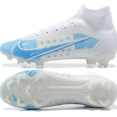 a pair of white and blue nike soccer cleats with the word's logo on