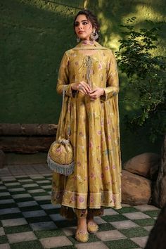 Yellow base anarkali with all over floral bloom prints and pleated flare. Paired with coordinating pant and dupatta with lace border. - Aza Fashions Yellow Floral Print Kurta For Wedding, Transitional Anarkali Set In Jamawar, Anarkali Palazzo Set With Floral Print And Traditional Drape, Designer Semi-stitched Floral Anarkali Set, Anarkali Style Semi-stitched Floral Sharara, Navratri Floral Anarkali Set With Traditional Drape, Navratri Anarkali Set With Floral Print, Diwali Jamawar Anarkali Set, Transitional Anarkali Kurta With Floral Print