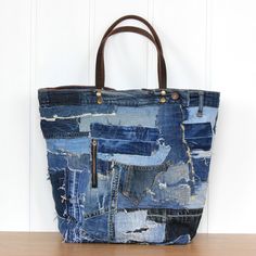 a bag made out of old jeans and leather handles